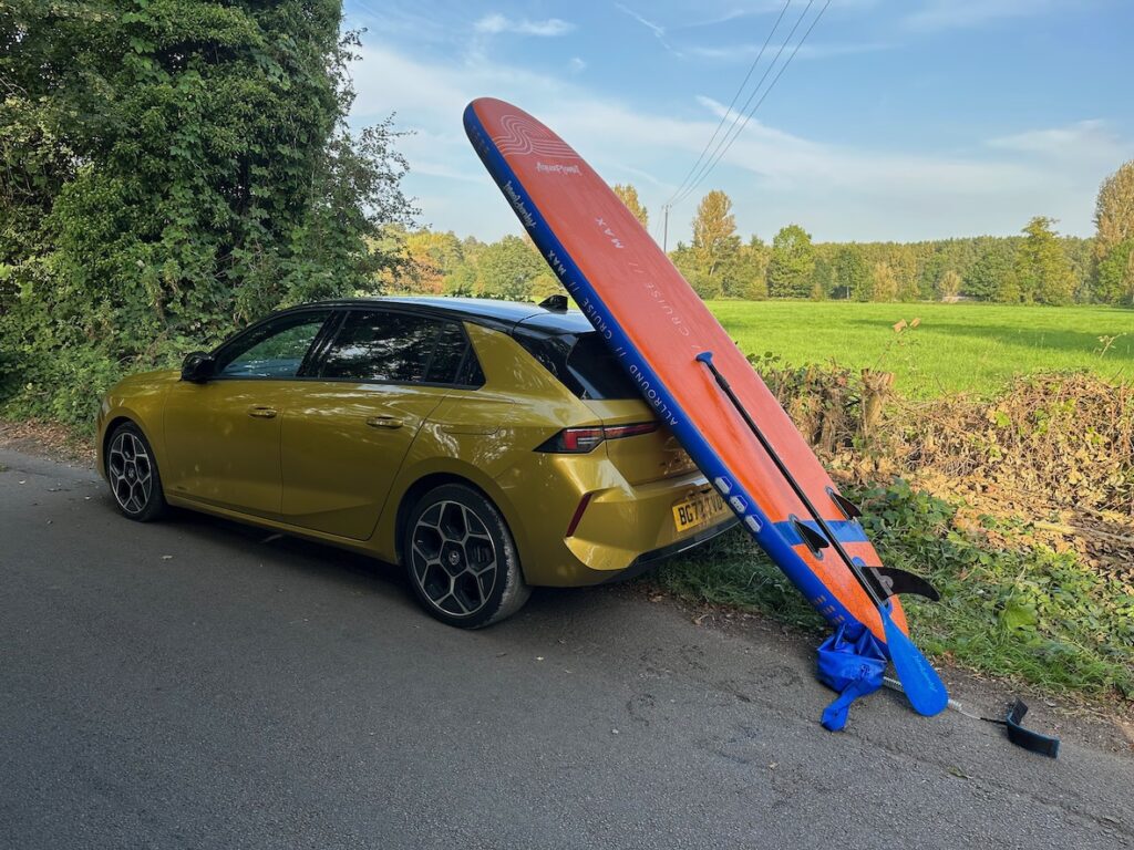 Gold Vauxhall Astra and paddle board