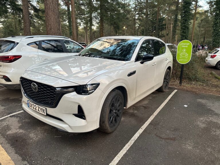 White Mazda CX60 PHEV charging on public charger