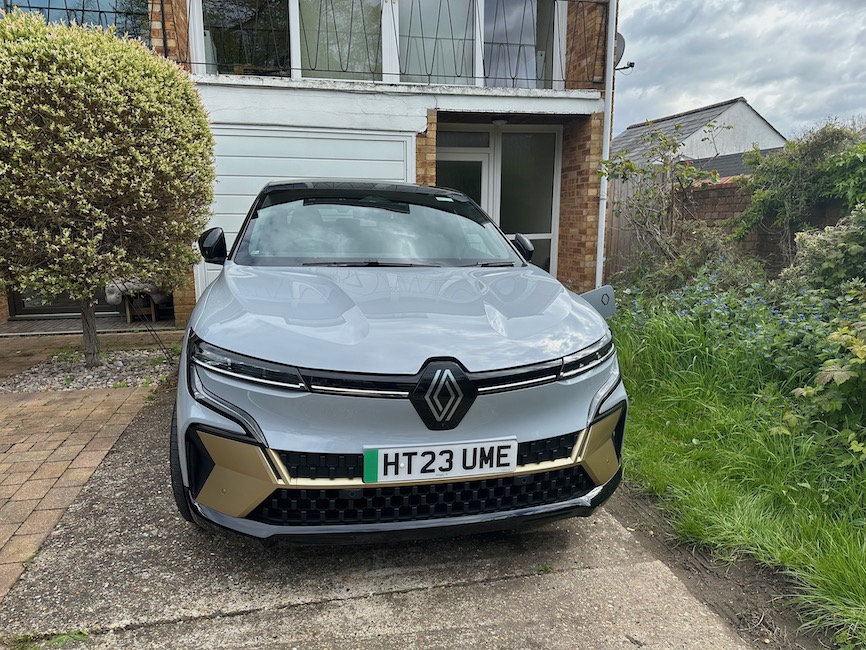 Grey Renault Megane E-tech parked outside house