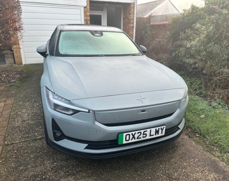Grey Polestar 2 iced up and parked outside house