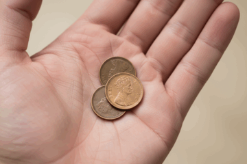 3 one pence pieces in palm of hand