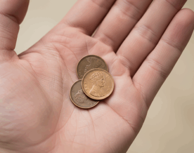 3 one pence pieces in palm of hand
